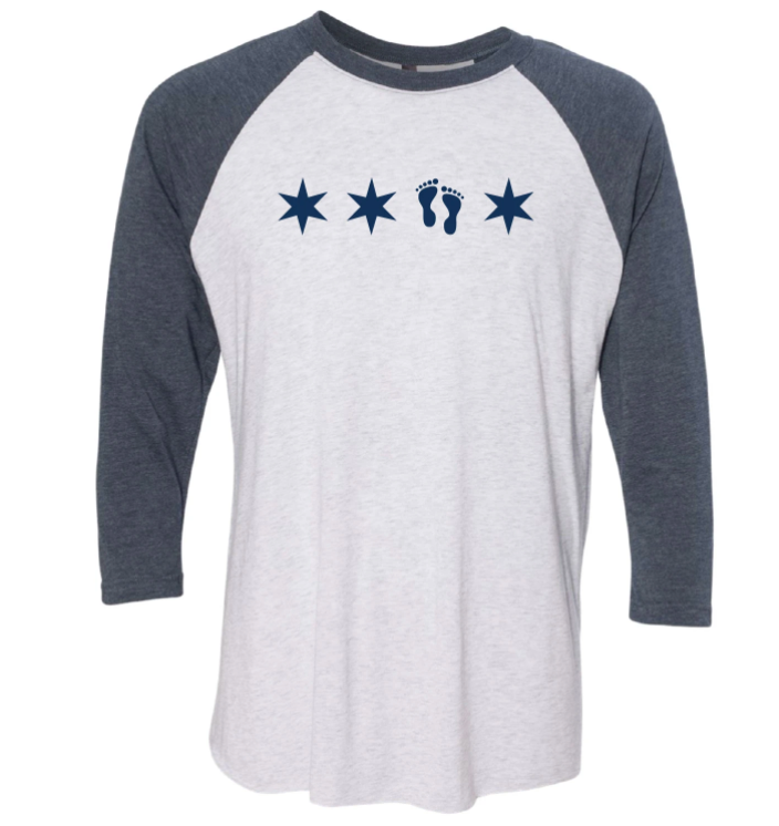 White and grey baseball T-shirt with a design of three stars and a pair of footprints.